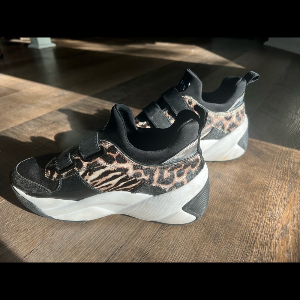 Michael Kors.   Comfortable and Eye catching. Love the calf hair/pony hair
